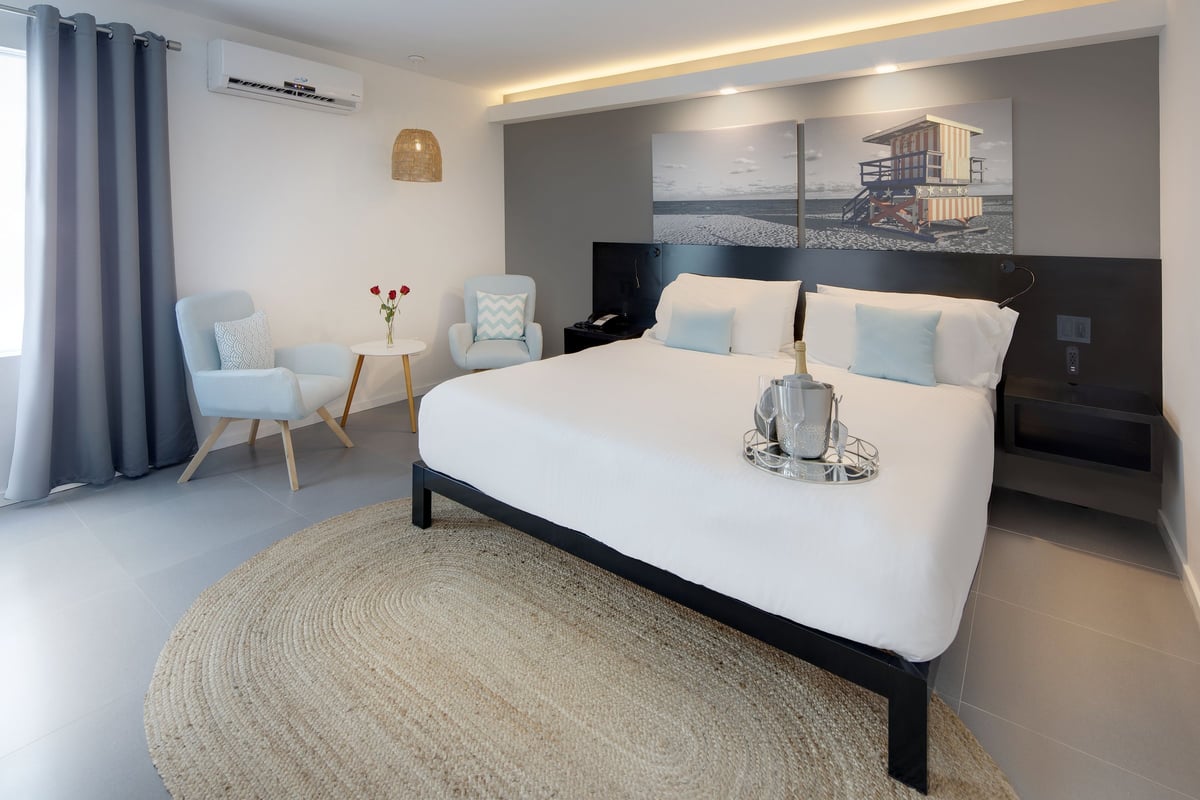 NK3 king room at MB Hotel prepared for a celebration, bed dressed with petals and a welcome setup