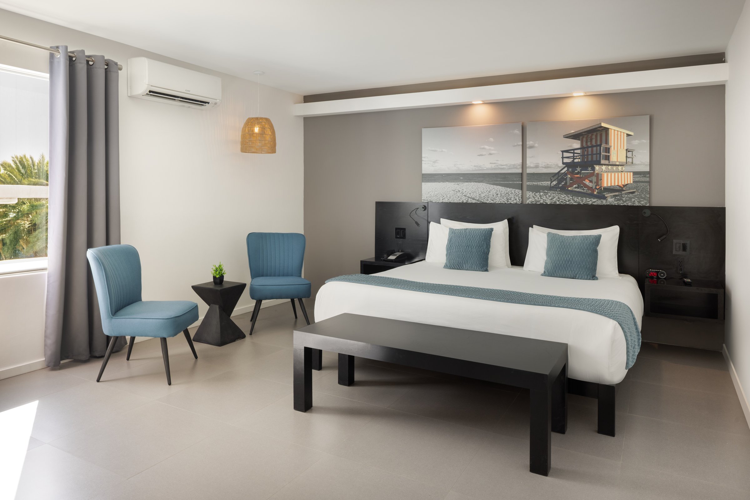 NK3 Superior Oversized King, wide corner room with seating and a made bed