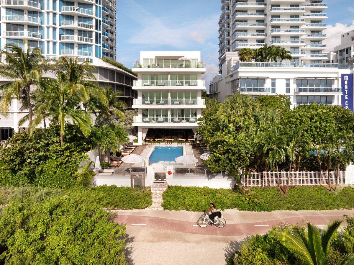 Aerial view over MB Hotel showing the pool deck, palm canopy and the Atlantic beyond
